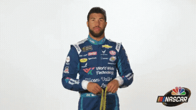 Man In NASCAR Uniform Holding Yellow Object GIF