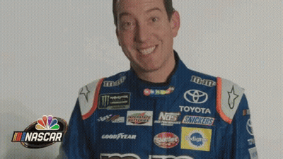 Man In Nascar Uniform Smiling Holding Snickers Bottle GIF