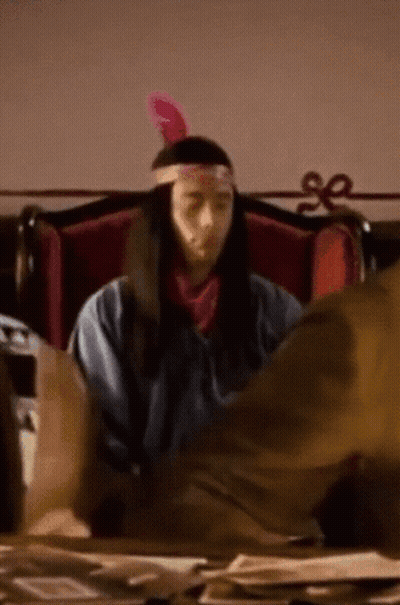 Man In Native American Costume At Desk GIF