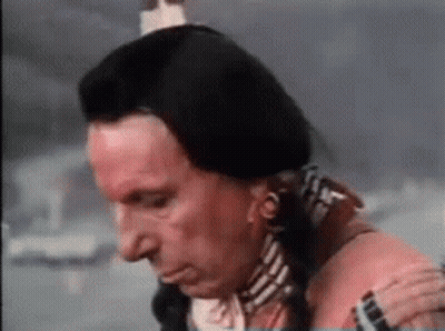 Man In Native American Costume Holding Shoulder Looking Down GIF