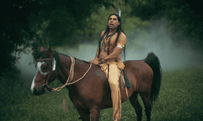 Man In Native American Outfit Rides Horse GIF