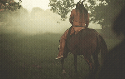 Man In Native American Outfit Riding Horse GIF