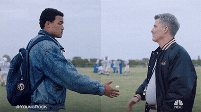 Man In NBC Jacket Talking On Football Field GIF