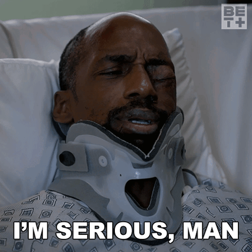 Man in Neck Brace Laying in Hospital Bed Saying I'm Serious Man