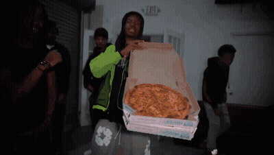 Man In Neon Green Jacket Holding Pizza Box GIF
