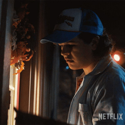Man In Netflix Hat Looking Out Window At Night GIF