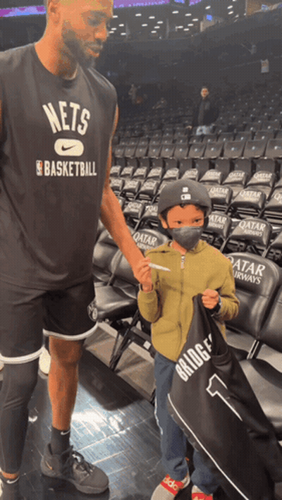 Man In Nets Basketball Shirt Talks To Boy GIF