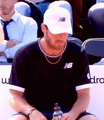 Man In New Balance Hat Holding Water In Stadium GIF