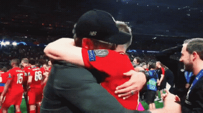 Man In New Balance Hat Hugging Another Man GIF