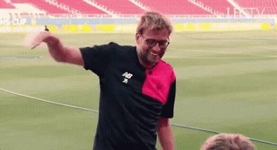Man In New Balance Shirt On Soccer Field Arms Outstretched GIF