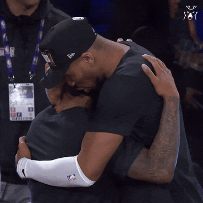 Man In New Era Hat Hugging Man In Black Shirt GIF