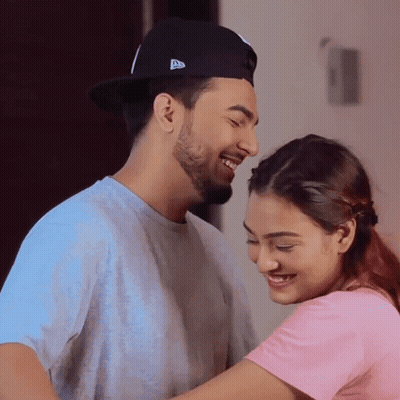 Man In New Era Hat Hugging Woman In Pink Shirt GIF