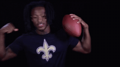 Man In New Orleans Saints Shirt Holding Football GIF