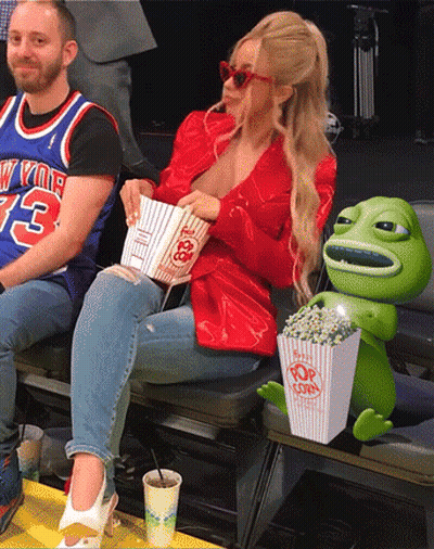Man In New York Jersey Sitting Next To Woman Holding Popcorn GIF