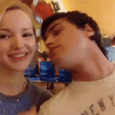 Man In New York Shirt Kissing Woman's Neck GIF