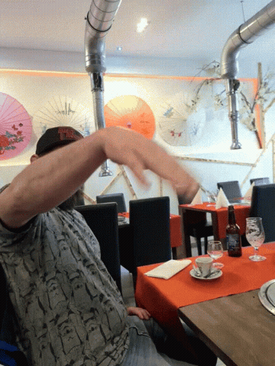 Man In New York Yankees Hat Sitting At Table GIF