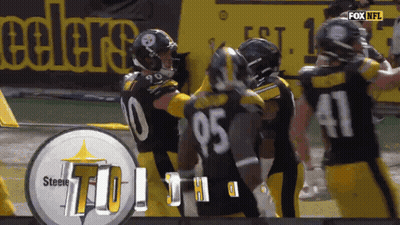 Man In NFL Hat Stands In Crowd GIF