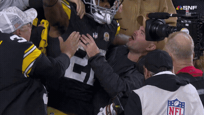 Man In NFL Jacket Holding Football Player's Chest GIF