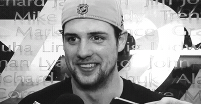 Man In NHL Hat In Front Of Wall Of Names GIF