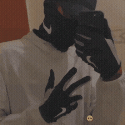 Man In Nike Gloves And Hat Taking Selfie GIF