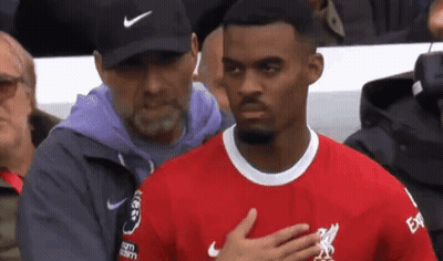 Man in Nike Hat Next to Man in Red Shirt