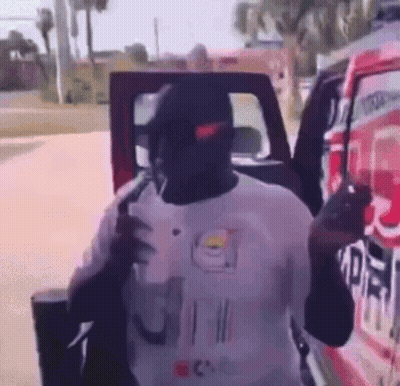 Man In Nike Hat Standing By Red Truck GIF