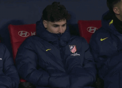 Man In Nike Jacket Sitting In Red Chairs GIF