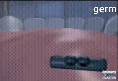 Man In Nike Jacket Standing Before Black Wall GIF