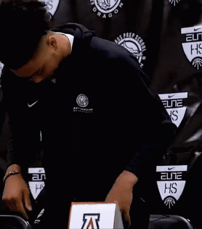 Man In Nike Jacket Standing In Front Of Black Wall GIF