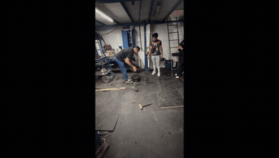 Man in Nike Shirt Kneeling in Garage