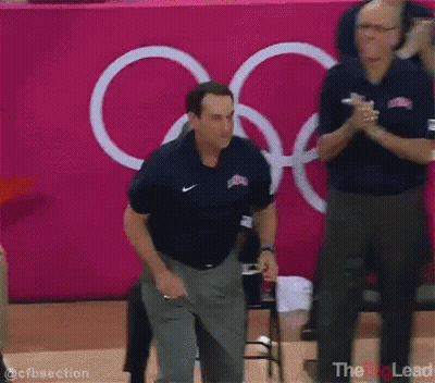 Man In Nike Shirt Pink Wall Olympic Rings GIF