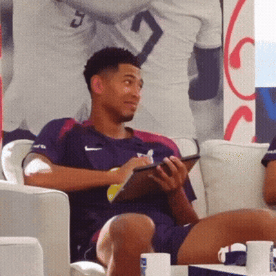 Man In Nike Shirt Sits On Couch GIF