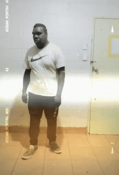 Man In Nike Shirt Standing In Front Of Kodak Portra 400 Film GIF