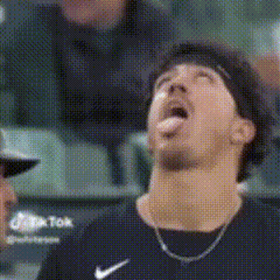 Man In Nike Shirt Sticking Tongue Out In Stadium GIF