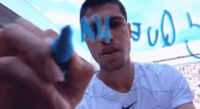Man In Nike Shirt Writing On Whiteboard GIF