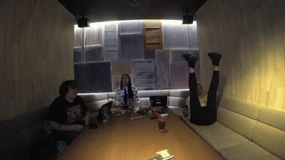 Man In Nirvana T-Shirt Sitting At Table With Two People GIF