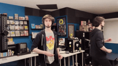 Man In NMS Shirt Standing In Room GIF