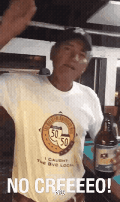Man in No Creeeeeo Shirt Holding Beer