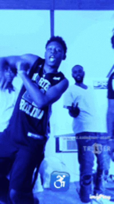 Man In North Carolina Jersey In Front Of Crowd GIF