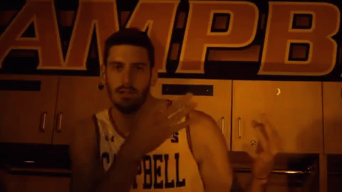 Man in Number 25 Jersey in Front of Campbell Sign