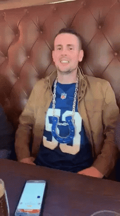 Man In Number 53 Shirt Sitting At Table GIF