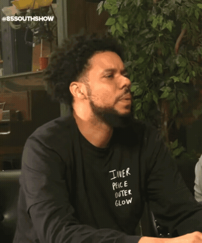 Man In Number 85 Jersey Sitting On Couch Next To Another Man GIF
