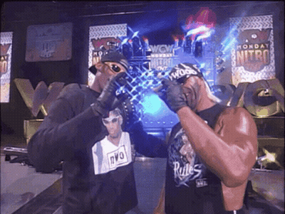 Man In NVO Shirt Standing Next To Another Man GIF