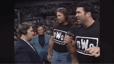 Man In NWO T-Shirt Talking Into Microphone GIF