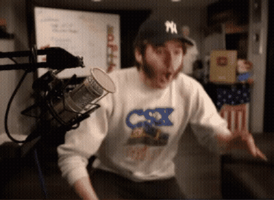 Man In NY Hat At Microphone GIF