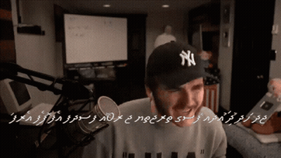 Man In NY Hat At Microphone GIF