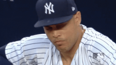 Man In NY Hat Looking Down GIF