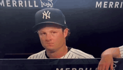Man In NY Yankees Hat Behind Merri Sign GIF