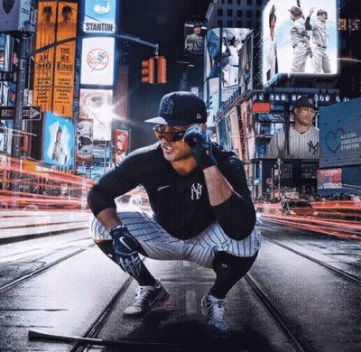 Man In NY Yankees Uniform Squatting With Bat GIF