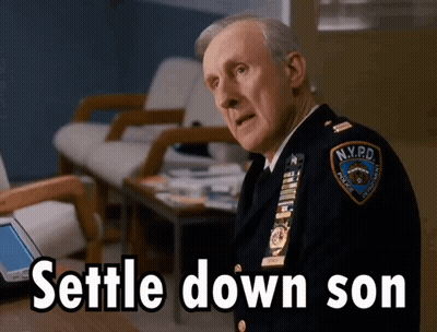 Man In NYPD Uniform Sitting At Table GIF